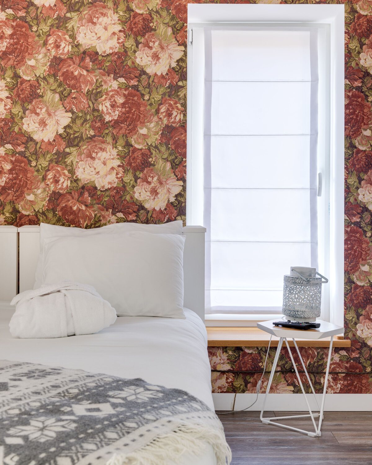 Bedroom with a botanical floral feature wall and crisp white bedding